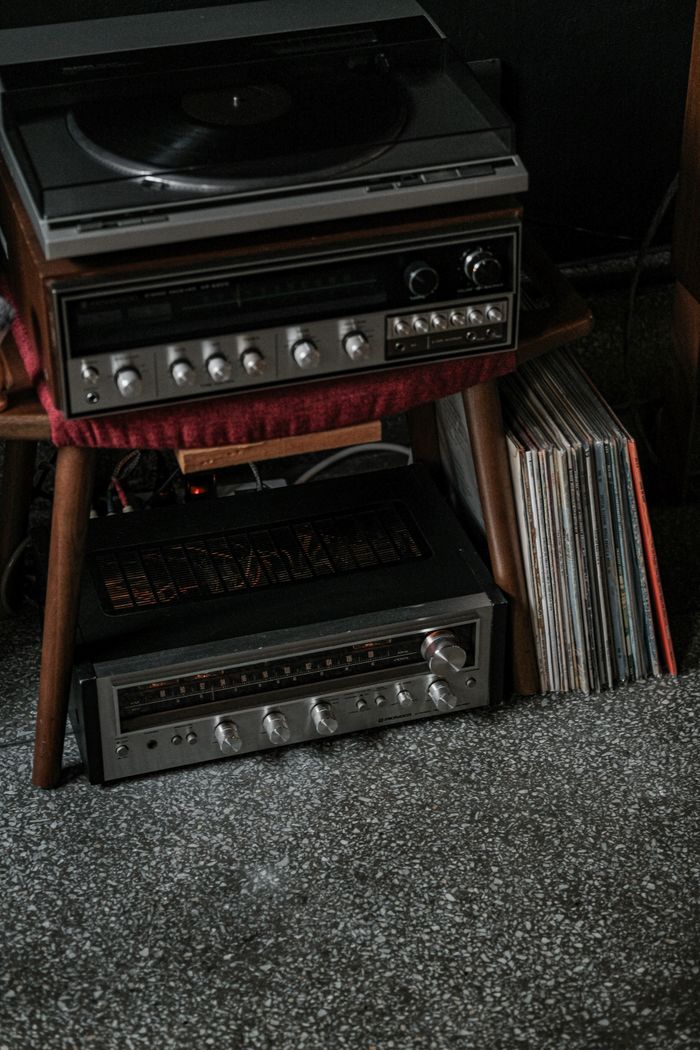 collection-02 Classic vinyl record player and audio equipment with stacked vinyl records, evoking nostalgia.